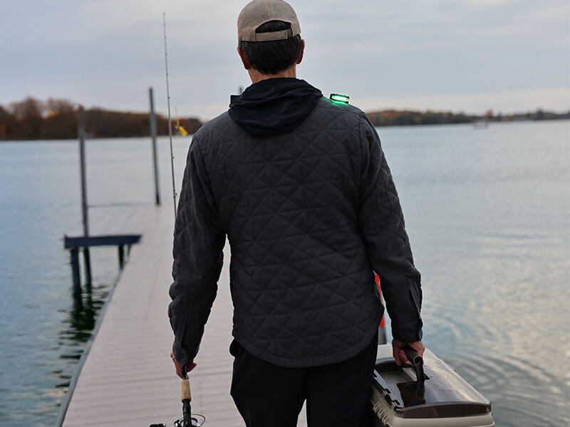 person with fishing gear wearing a guardian angel safety light device
